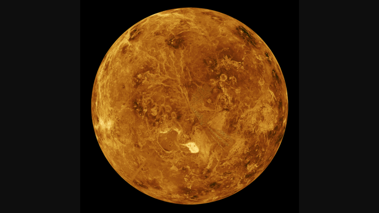  A view of Venus against a black background. It looks awfully scorching in its amber hue. 