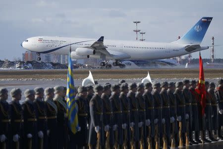 A plane with Iranian President Hassan Rouhani onboard lands as Russian honour guards line up before a welcoming ceremony at Vnukovo International Airport in Moscow, Russia March 27, 2017. REUTERS/Maxim Shemetov