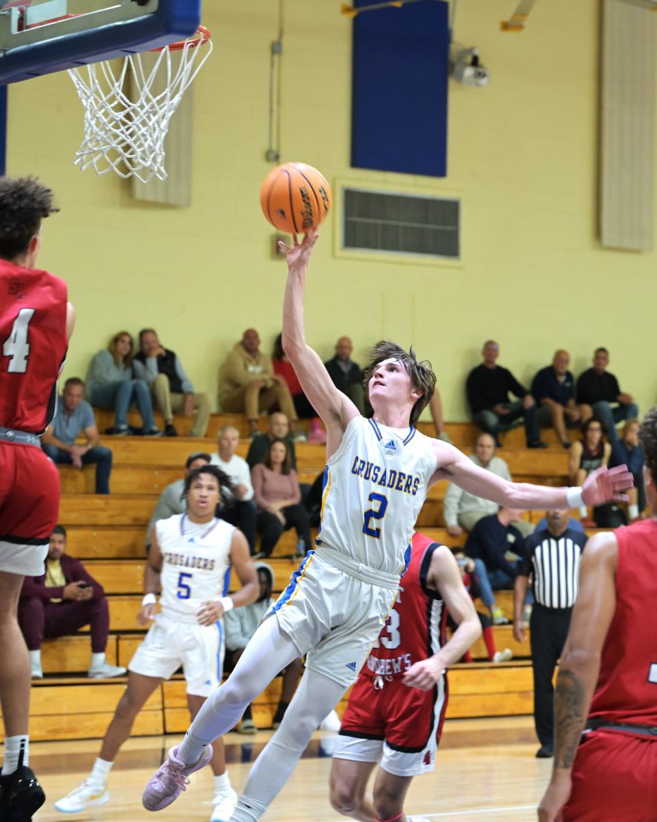 Cardinal Newman point guard Joe Duran (2) goes in strong for the lay up during a game against Saint Andrews on Jan. 30, 2024.