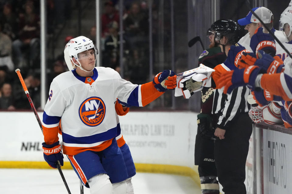 New York Islanders defenseman Mike Reilly, left, celebrates after his goal against the Arizona Coyotes during the first period of an NHL hockey game Thursday, Jan. 4, 2024, in Tempe, Ariz. (AP Photo/Ross D. Franklin)