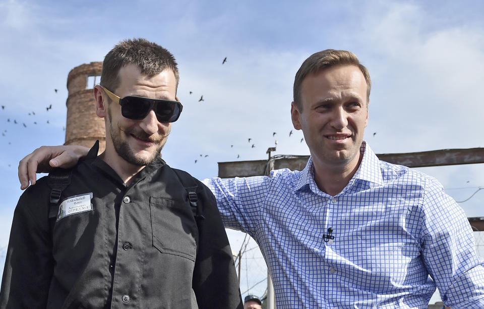 FILE - In this file photo taken on Friday, June 29, 2018, Russian opposition leader Alexei Navalny, right, poses for a photo with his brother Oleg Navalny, center, after Oleg's release from prison in Naryshkino, Orel region, 380 kilometers (237 miles) south of Moscow, Russia. (AP Photo/Dmitry Serebryakov)