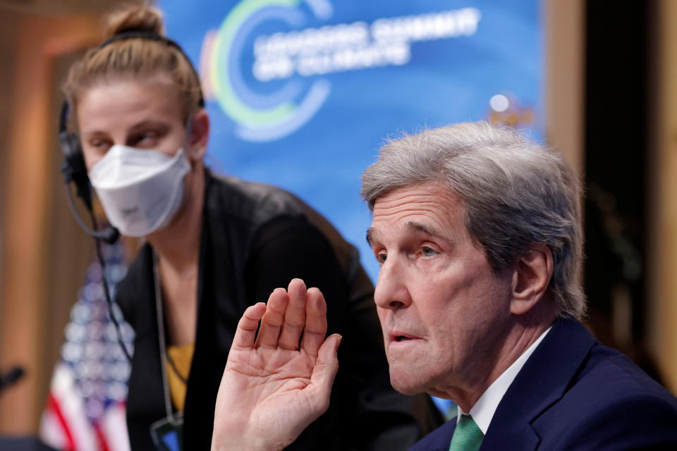 U.S. Special Presidential Envoy for Climate John Kerry greets Transportation Secretary Pete Buttigieg, not pictured, ahead of a virtual Climate Summit with world leaders in the East Room at the White House in Washington, U.S., April 23, 2021. REUTERS/Tom Brenner