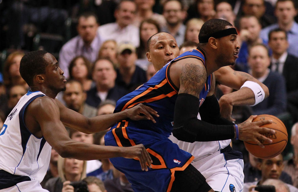 Carmelo Anthony (middle) dribbles the ball against Shawn Marion and Rodrigue Beaubois (left) of the Dallas Mavericks at American Airlines Center on March 6, 2012 in Dallas. (Photo by Ronald Martinez/Getty Images)