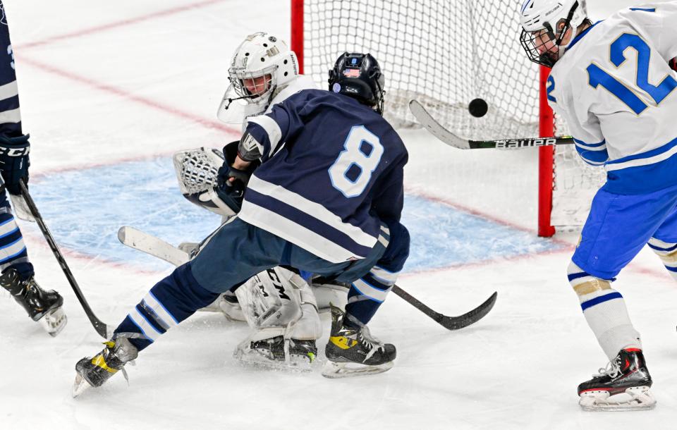 Shane Corcoran of Sandwich puts a shot on Norwell goalie Sean Donovan that just misses in the MIAA Division 4 final hockey match on March 19.