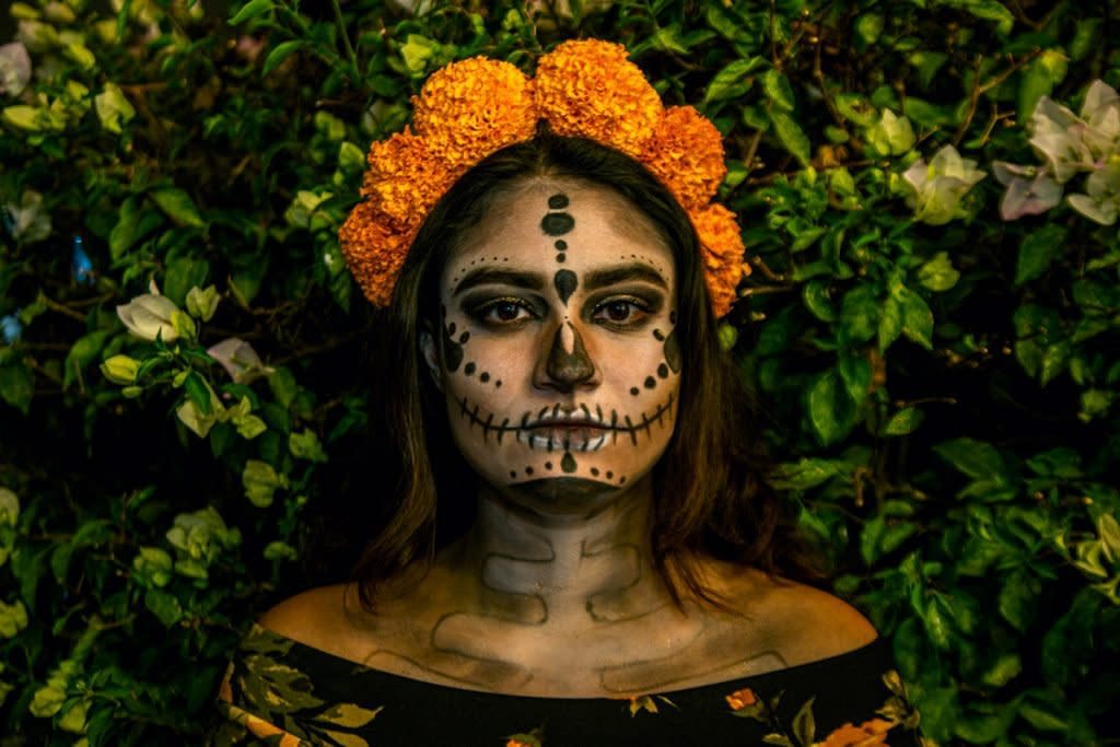 A woman dresses up for Day of the Dead.