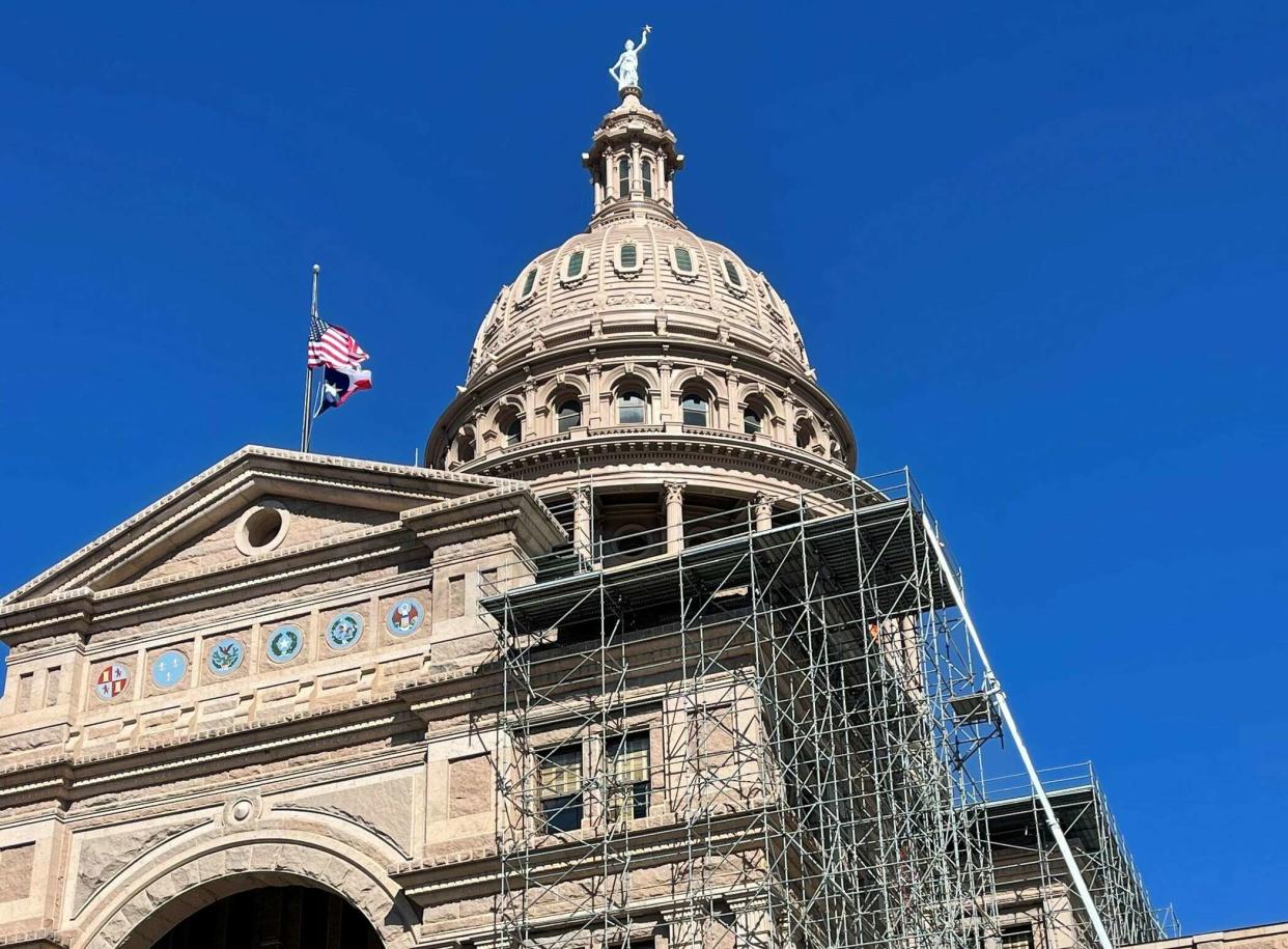 Scaffolding at the Capitol protects workers as they replace the leaky roof and seal openings to keep out birds.