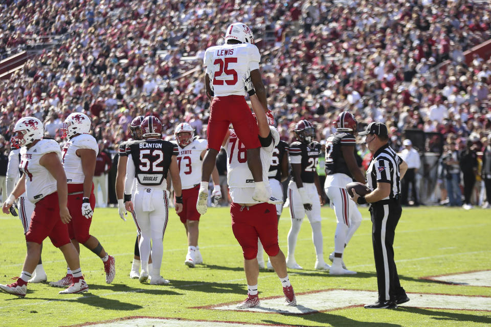 Jacksonville State running back Anwar Lewis (25) is lifted in the air by offensive lineman Brock Robey (78) after scoring a touchdown during the first half of an NCAA college football game against South Carolina on Saturday, Nov. 4, 2023, in Columbia, S.C. (AP Photo/Artie Walker Jr.)