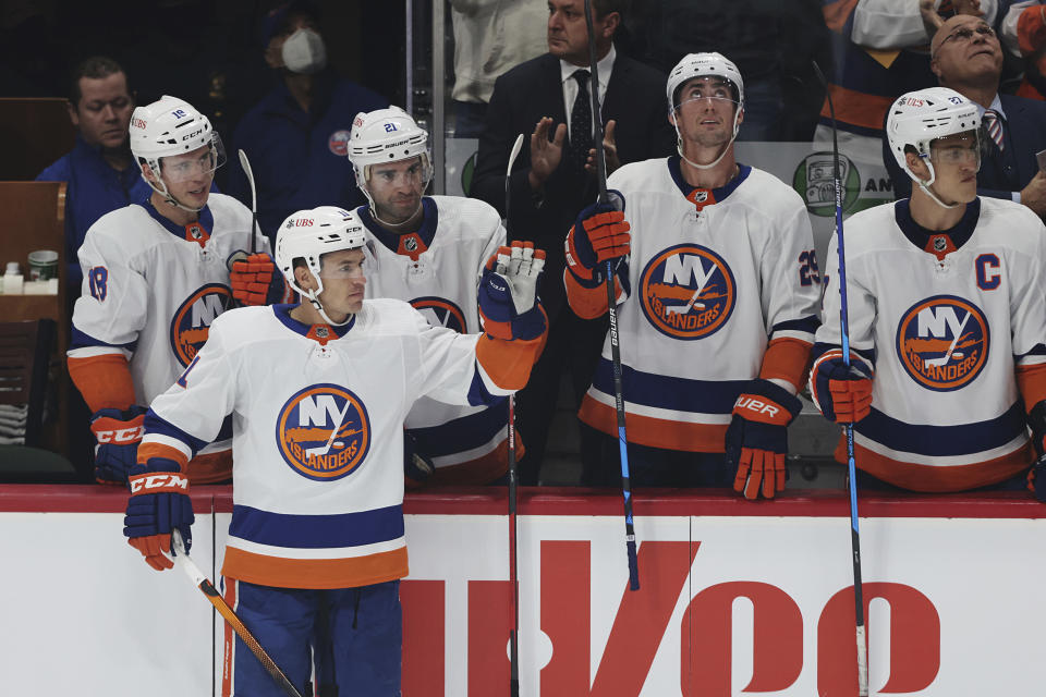 New York Islanders' Zach Parise (11), former team member of the Minnesota Wild, waves to fans after being highlighted in a video during the first period of an NHL hockey game against the Minnesota Wild, Sunday, Nov. 7, 2021, in St. Paul, Minn. (AP Photo/Stacy Bengs)