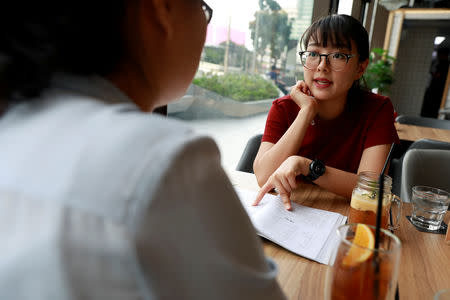 Chinese national Cherry He Ting (L) teaches a student in a coffee shop in Bangkok, Thailand, November 18, 2018. Picture taken November 18, 2018. REUTERS/Soe Zeya Tun