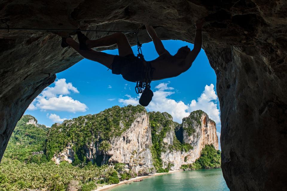 Person climbing rock cliff in Railey, Thailand