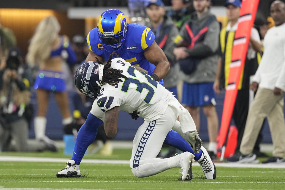 Los Angeles Rams linebacker Bobby Wagner, top, intercepts a pass intended for Seattle Seahawks running back Tony Jones Jr. (32) during the second half of an NFL football game Sunday, Dec. 4, 2022, in Inglewood, Calif. (AP Photo/Mark J. Terrill)