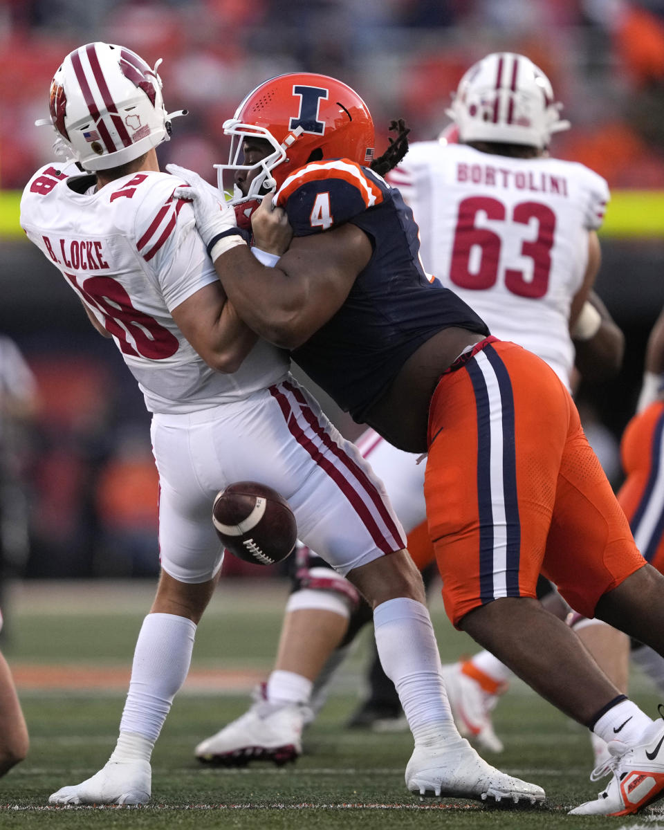 Illinois defensive lineman Jer'Zhan Newton hits Wisconsin quarterback Braedyn Locke during the second half of an NCAA college football game Saturday, Oct. 21, 2023, in Champaign, Ill. Newton was called for targeting and ejected from the game. (AP Photo/Charles Rex Arbogast)