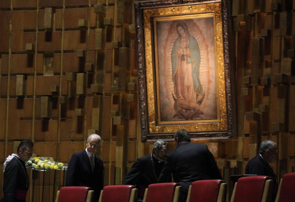 Then-Vice President Joe Biden leaves after placing a flower arrangement under an image of the Virgin of Guadalupe during a visit to the Basilica of Guadalupe in Mexico City, Monday, March 5, 2012. Biden is on a one-day official visit to Mexico. (AP Photo/Alexandre Meneghini)