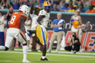 Pittsburgh running back Israel Abanikanda (2) runs past Miami cornerback DJ Ivey (8) to score a touchdown during the first half of an NCAA college football game, Saturday, Nov. 26, 2022, in Miami Gardens, Fla. (AP Photo/Lynne Sladky)