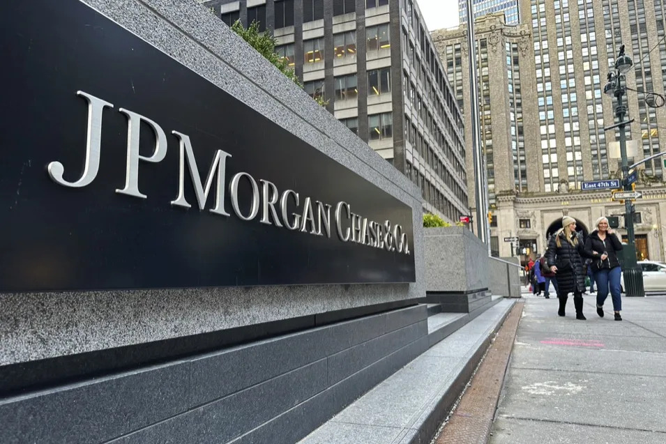 FILE - Pedestrians approach JPMorgan Chase headquarters on Dec. 29, 2023, in New York. JP Morgan reports earnings on Friday, April 12, 2024. (AP Photo/Peter Morgan, File)