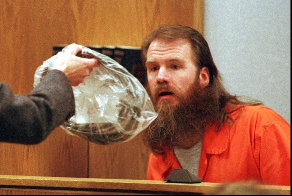 Dan Lafferty looks at evidence Tuesday, April 2, 1996, during testimony in the retrial for the 1984 murders of Brenda and Erica Lafferty in Provo, Utah. The evidence seen is a vacuum cord that was tied around Brenda Lafferty’s neck. - Credit: (AP Photo/Stuart W. Johnson, pool)