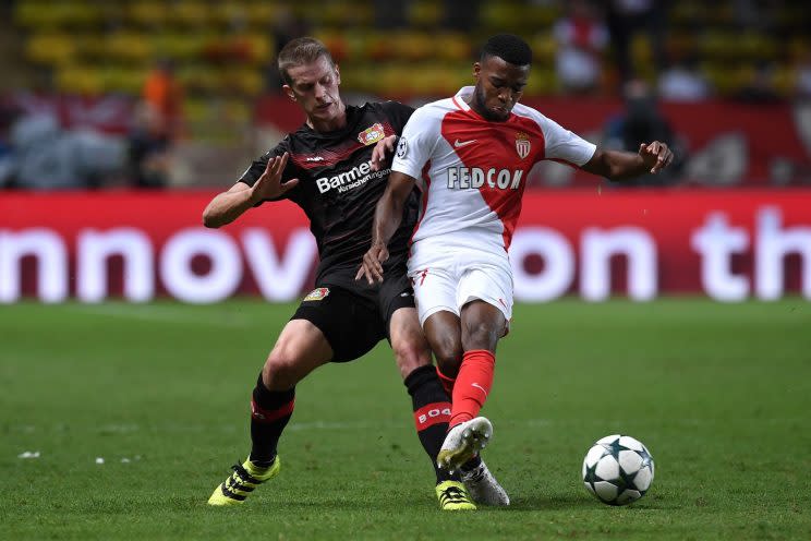 Thomas Lemar (R) of AS Monaco FC is challenged by Lars Bender of Bayer 04 Leverkusen during the UEFA Champions League