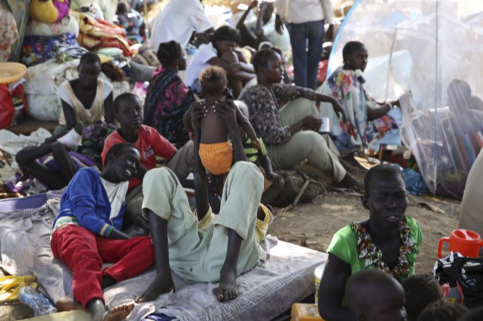 An internally displaced man plays with his child inside a UNMIS compound in Juba