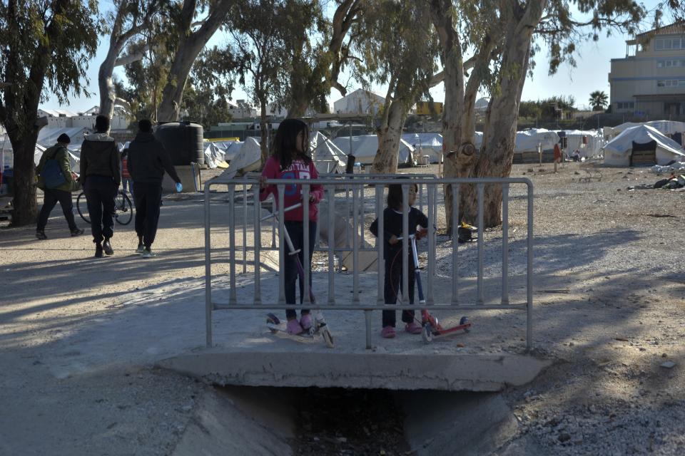 Migrants gather at Karatepe refugee camp, on the northeastern Aegean island of Lesbos, Greece, Thursday, Nov. 25, 2021. Pope Francis is heading back to the Greek island of Lesbos to meet migrants and asylum seekers for the second time in five years. (AP Photo/Panagiotis Balaskas)