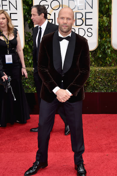 Jason Statham wearing a chocolate-colored velvet jacket at the 73rd Golden Globe Awards.