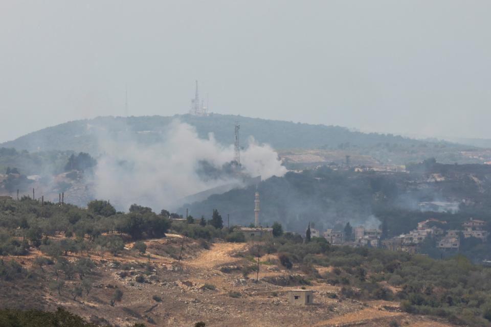 Smoke rises from Dhayra village after Israeli shelling as pictured from the Lebanese town of Marwahin, near the border with Israel (REUTERS)