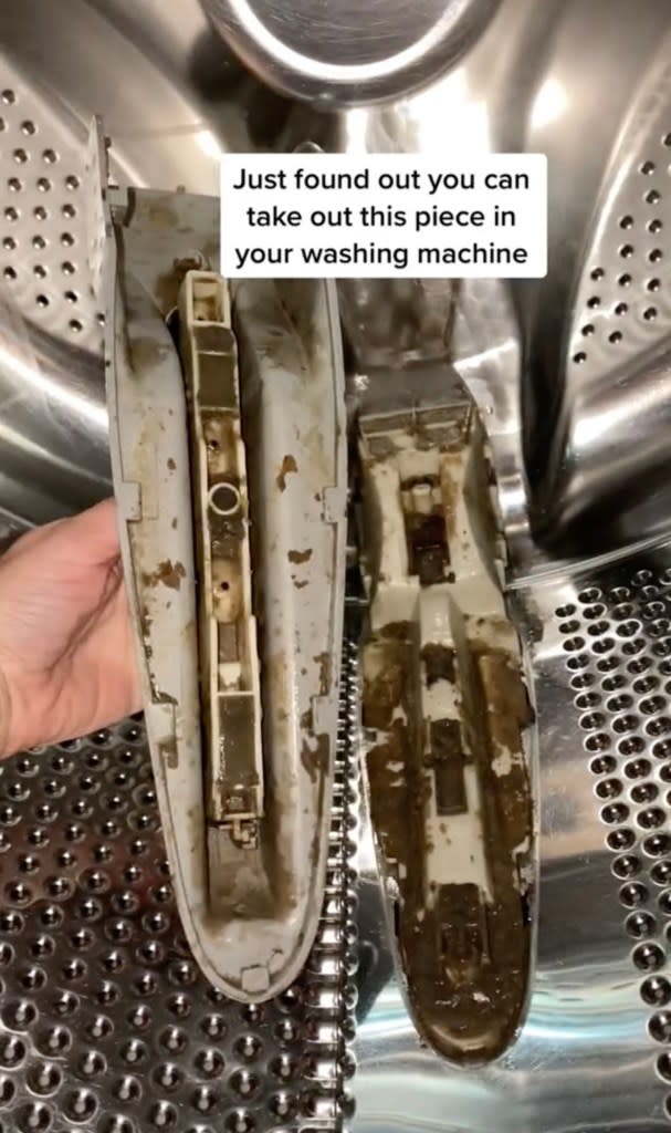 Jessie unlatched the partition in her LG front loader washing machine exposing the built-up brown residue. TikTok / @jessiee_marie