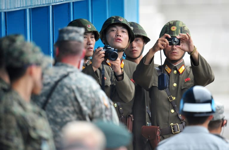 North Korean soldiers look at the South side at the truce village of Panmunjom in the Demilitarized zone (DMZ) dividing the two Koreas on July 27, 2013