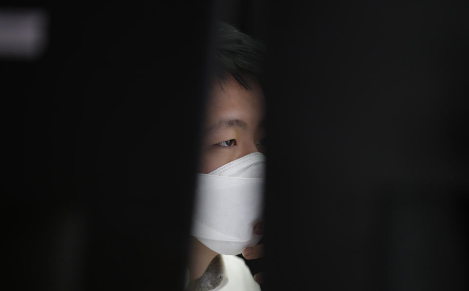 An employee of a bank wearing a face mask watches the computer monitors at the foreign exchange dealing room in Seoul, South Korea, Thursday, April 9, 2020. Asian shares are mixed, with Tokyo lower, as an overnight rally on Wall Street faded.(AP Photo/Lee Jin-man)