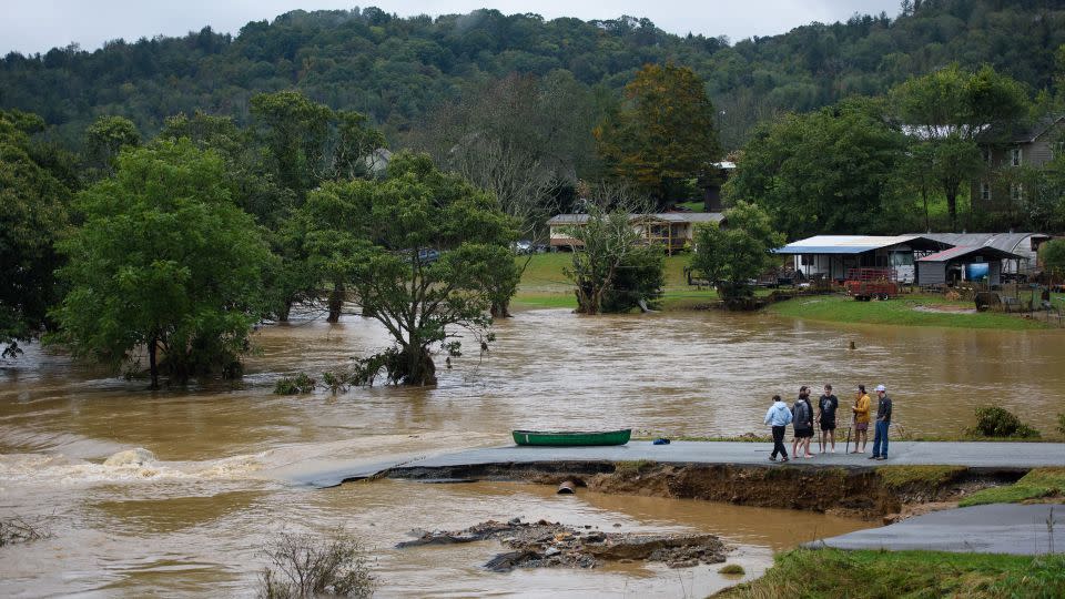 Residents talk after having canoed the flooded South Fork New River for 32 minutes and landing at a washed out road on September 27, 2024 in Boone, North Carolina. - Melissa Sue Gerrits/Getty Images