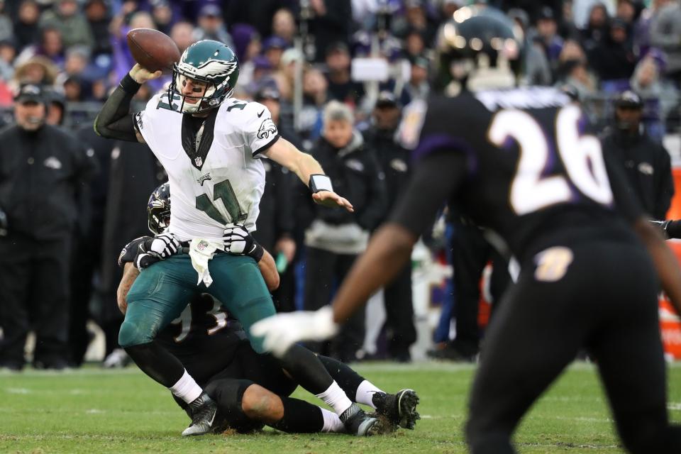 <p>Quarterback Carson Wentz #11 of the Philadelphia Eagles is pulled down by defensive end Lawrence Guy #93 of the Baltimore Ravens in the second quarter at M&T Bank Stadium on December 18, 2016 in Baltimore, Maryland. (Photo by Rob Carr/Getty Images) </p>