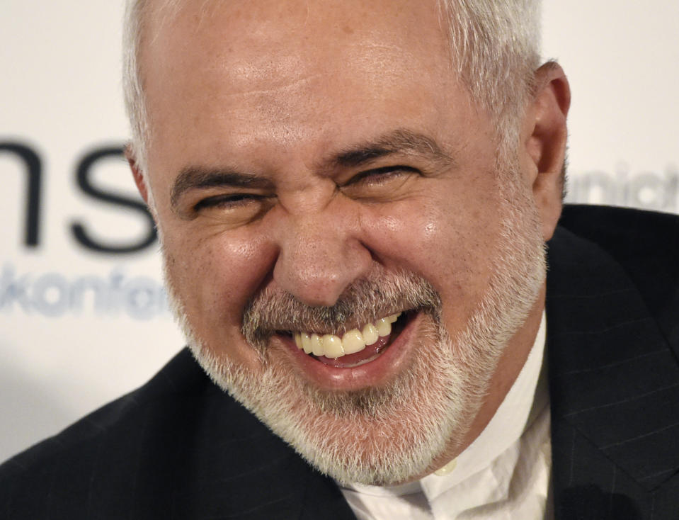 Iranian Foreign Minister Mohammad Javad Zarif laughs on the second day of the Munich Security Conference in Munich, Germany, Saturday, Feb. 15, 2020. (AP Photo/Jens Meyer)