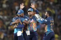 Sri Lanka's Pramod Madushan, left, celebrates after taking the wicket of Australia's Mitchell Marsh with teammates during the fifth one-day international cricket match between Australia and Sri Lanka in Colombo, Sri Lanka, Friday, June 24, 2022. (AP Photo/Eranga Jayawardena)