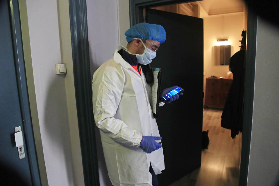 In this photo taken Saturday March 28, 2020, member of the Civil Protection service Cyril Lamriben waits for a phone call from a doctor before checking a woman possibly infected with the Covid-19 disease in Paris. They don't have to put themselves in harm's way, but the volunteers of France's well-known Civil Protection service choose the front line in the fight against the coronavirus. (AP Photo/Michel Euler)