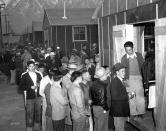 <p>Japanese citizens wait in line for their assigned homes at an internment camp reception center in Manzanar, Calif., on March 24, 1942. Many were forced from their homes in Los Angeles by the U.S. Army. (AP Photo) </p>