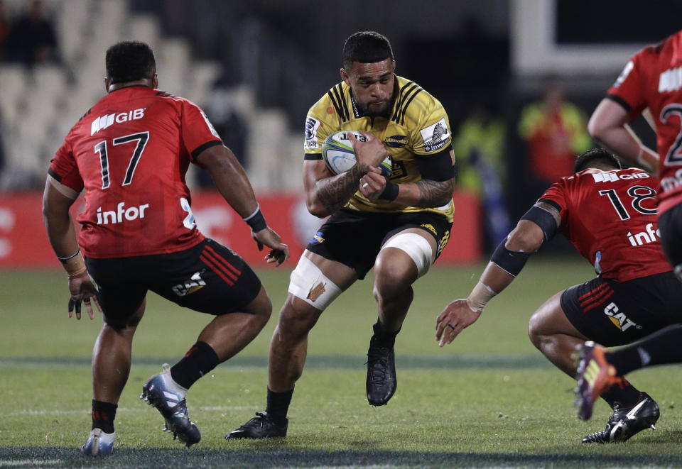 FILE - In this Saturday June 29, 2019 file photo,Hurricanes Vaea Fifita runs at the Crusaders defence during the Super Rugby semifinal between the Crusaders and the Hurricanes in Christchurch, New Zealand, Saturday. A domestic tournament involving New Zealand’s five Super Rugby teams will begin in mid-June after the New Zealand government Monday, May 11, 2020, loosened restrictions on sporting competitions, imposed because of the coronavirus pandemic (AP Photo/Mark Baker, File)