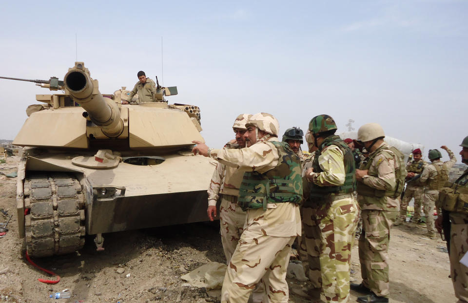 In this photo released by the Iraqi Army taken on March 20, 2014, Iraqi Security forces prepare to attack al-Qaida positions in Ramadi, 70 miles (115 kilometers) west of Baghdad, Iraq. Iraqi military officials are warning that efforts to clear militants from Fallujah and parts of nearby Ramadi are proving much more difficult than they anticipated when the jihadists showed up three months ago. That realization, as they acknowledged during a recent tour of special forces operations, casts doubt on Iraq's ability to hold elections in Fallujah next month. (AP Photo/Iraqi Army)