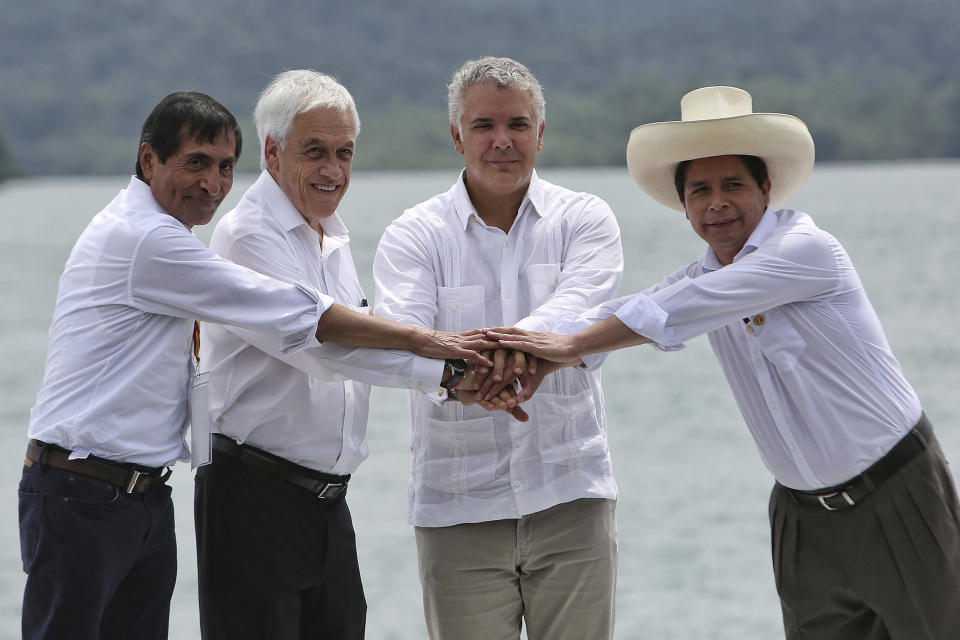 FILE - Peru's President Pedro Castillo, right, poses for a photo at the XVI Summit of the Pacific Alliance with leaders, from left, Mexico's Secretary of Finance and Public Credit of Mexico Rogelio Ramirez, Chile's President Sebastian Pinera and Colombia's President Ivan Duque, in Bahia Malaga, Colombia, Wednesday, Jan. 26, 2022. After a year in office, President Pedro Castillo has seen his poll number fall as his administration has been beset by a myriad of troubles, ranging from accusations of corruption to having parliament attempt to remove him twice from office. (AP Photo/Andres Gonzalez, File)