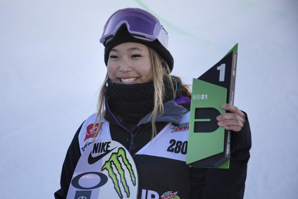 FILE - Chloe Kim, of the United States, holds the first place finish following the snowboarding halfpipe finals, Sunday, Dec. 19, 2021, during Dew Tour at Copper Mountain, Colo. Shaun White is likely heading to the Olympics for a fifth time. For the first time, the snowboarding star and three-time gold medalist on the halfpipe won't be the favorite. That won't be the case on the women's side, where Chloe Kim will attempt to defend the gold that she claimed with such ease in Korea four years ago. (AP Photo/Hugh Carey, FIle)