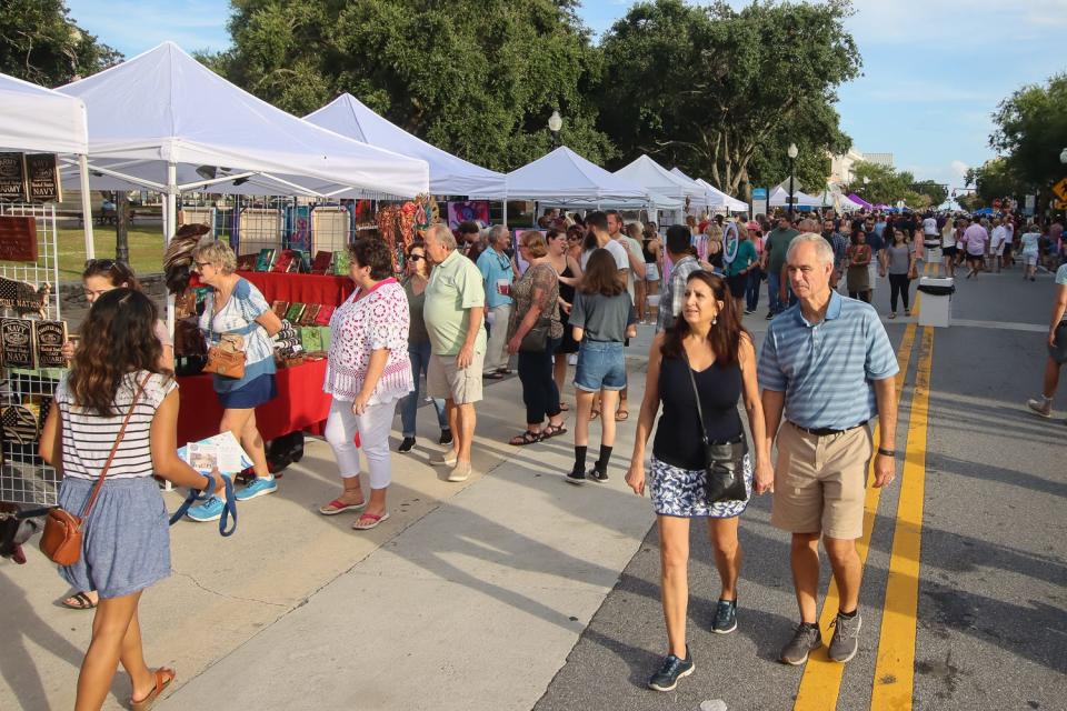 People make their way around Palafox Place in downtown Pensacola during Gallery Night on July 16, 2021.