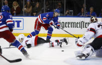 New York Rangers right wing Vitali Kravtsov (74) passes the puck to Filip Chytil, left, as Ottawa Senators goalie Cam Talbot watches and defenseman Artem Zub goes to the ice during the second period of an NHL hockey game Friday, Dec. 2, 2022, in New York. (AP Photo/John Munson)