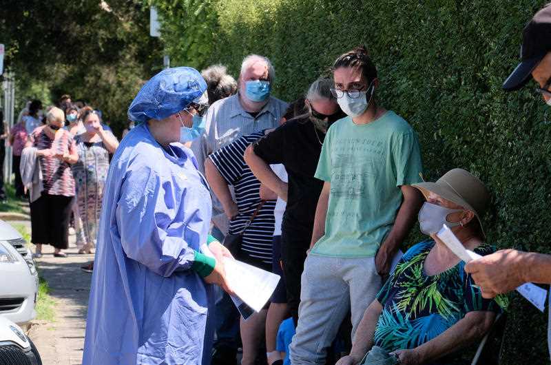 People line up as they wait to be tested for Covid19 at the Sunbury Respiratory Clinic in Melbourne.