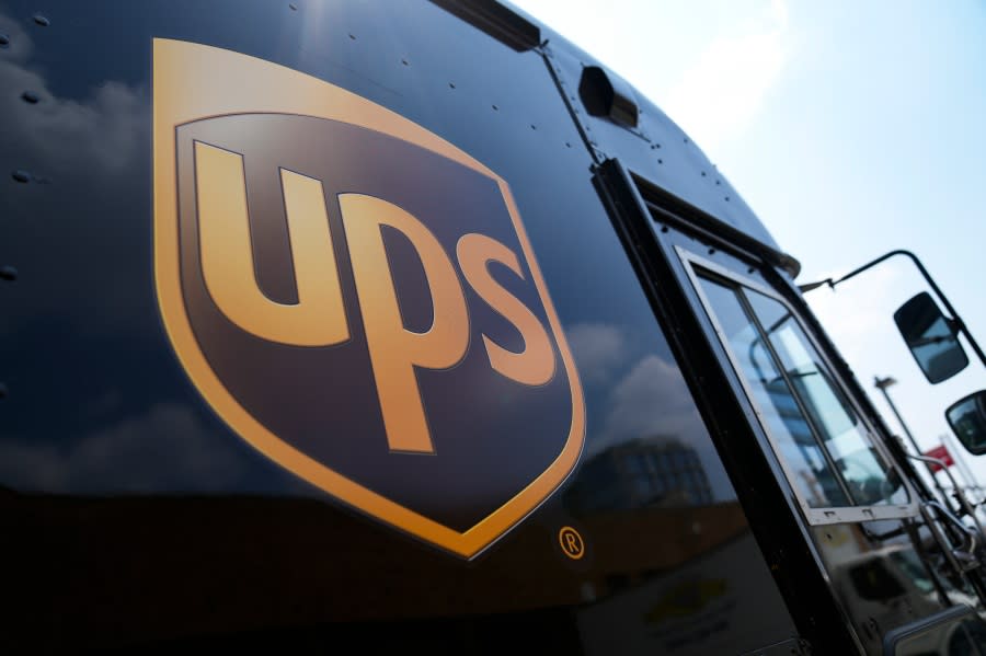 Delivery vehicles idle outside a UPS depot June 29 in New York. (AP Photo/John Minchillo)