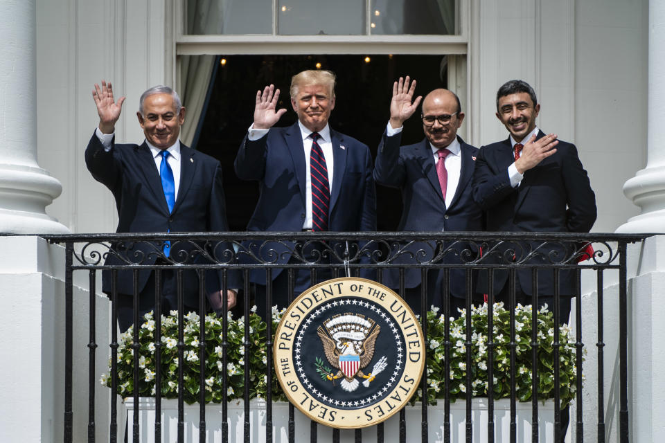 Israeli Prime Minister Benjamin Netanyahu, President Trump, Bahrain Foreign Minister Khalid bin Ahmed Al Khalifa and United Arab Emirates Foreign Minister Abdullah bin Zayed Al-Nahyan wave from a balcony at the White House