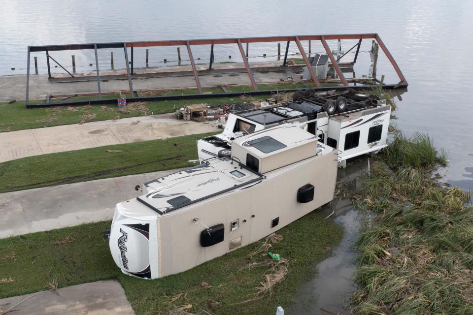 In this aerial photo taken with a drone, flood waters surround overturned campers, Tuesday, Aug. 31, 2021, in Lafourche Parish, La., as residents try to recover from the effects of Hurricane Ida. 