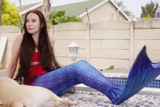 <p>TLC</p> Holly shows off her new mermaid tail to husband, Wayne.