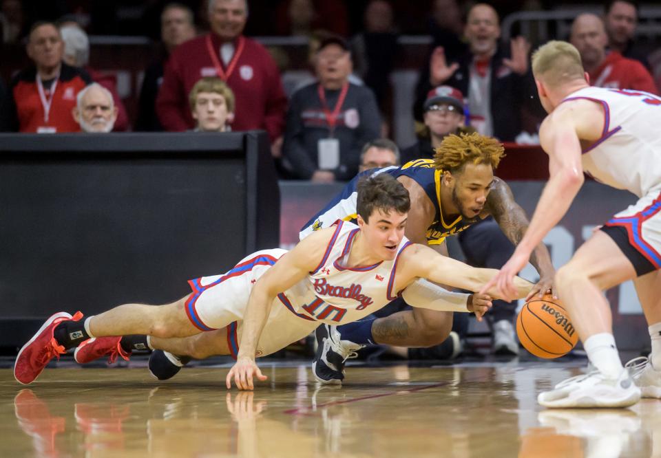 Bradley's Connor Hickman (10) and Murray State's DJ Burns dive for a loose ball in the first half Saturday, Feb. 11, 2023 at Carver Arena. The Braves rolled over the Racers 83-48.