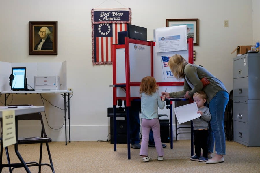 Lauren Miracle, helps her children Dawson, 1, and Oaklynn, 3, fill out children’s practice ballots before voting herself at a polling location in the Washington Township House in Oregonia, Ohio, Tuesday, Nov. 7, 2023. Polls are open in a few states for off-year elections that could give hints of voter sentiment ahead of next year’s critical presidential contest. (AP Photo/Carolyn Kaster)