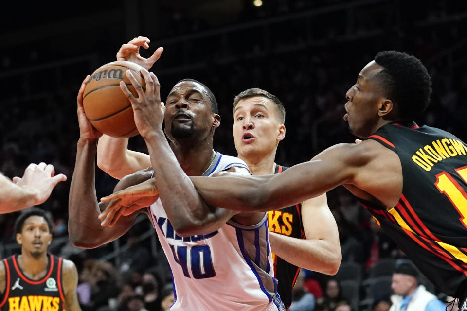 Sacramento Kings forward Harrison Barnes (40) tries to get past Atlanta Hawks forward Onyeka Okongwu (17) in the second half of an NBA basketball game Wednesday, Jan. 26, 2022, in Atlanta. (AP Photo/John Bazemore)