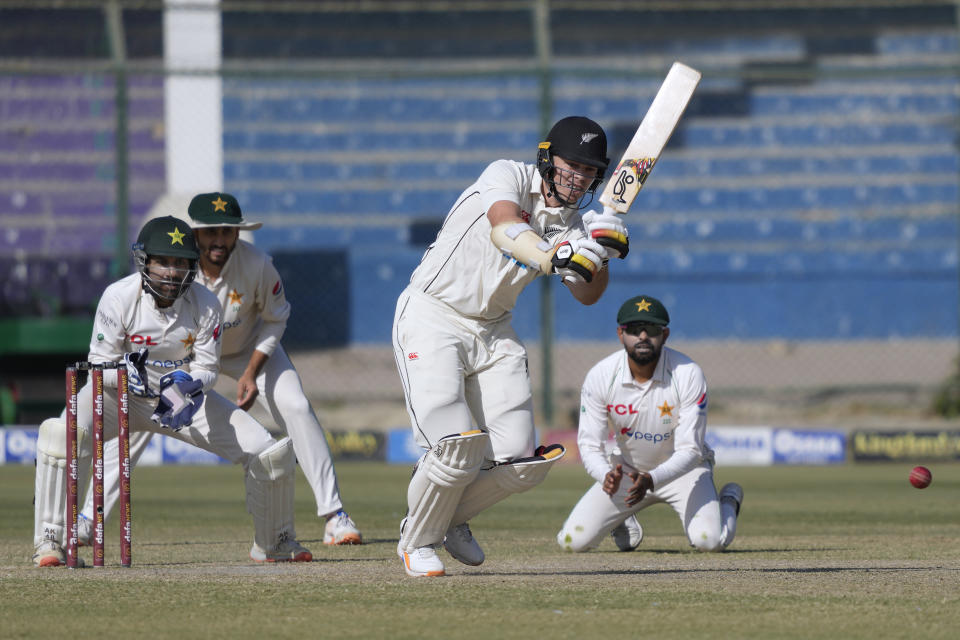 New Zealand's Michael Bracewell, center, plays a shot as Pakistan's Sarfraz Ahmed, left, Agha Salma, second left, and Babar Azam watch during the fourth day of the second test cricket match between Pakistan and New Zealand, in Karachi, Pakistan, Thursday, Jan. 5, 2023. (AP Photo/Fareed Khan)