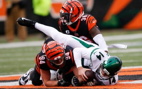 New York Jets quarterback Sam Darnold (14) is sacked by Cincinnati Bengals strong safety Shawn Williams (36) during the second half of an NFL football game, Sunday, Dec. 1, 2019, in Cincinnati - Credit: AP